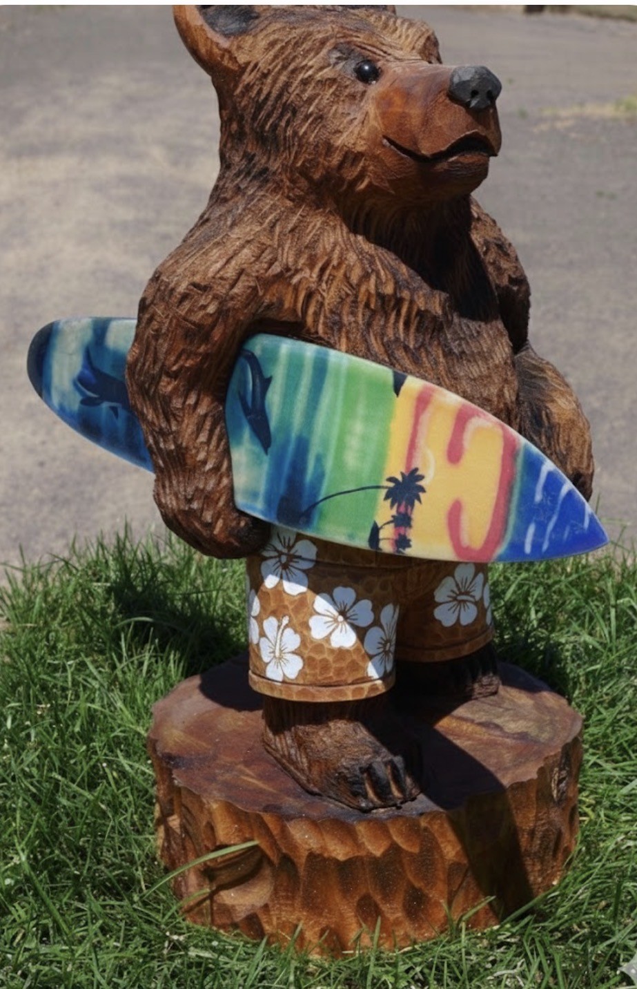 Bear in Shorts holding Surfboard